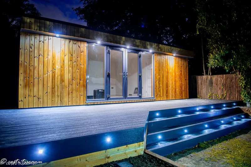 Completed timber-clad garden room and illuminated decking