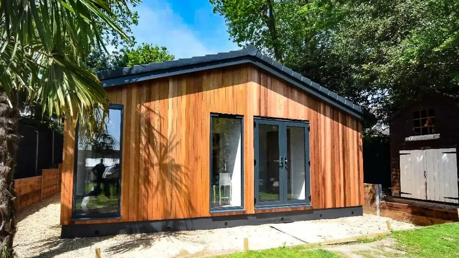 TRJ timber-clad granny annexe beside a garden
