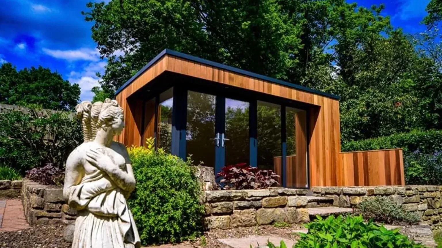TRJ cedar-clad garden room with full-height glazing