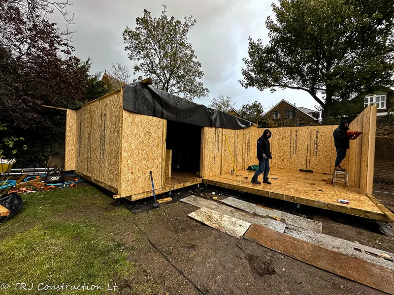 SIP wall panels during garden-building assembly