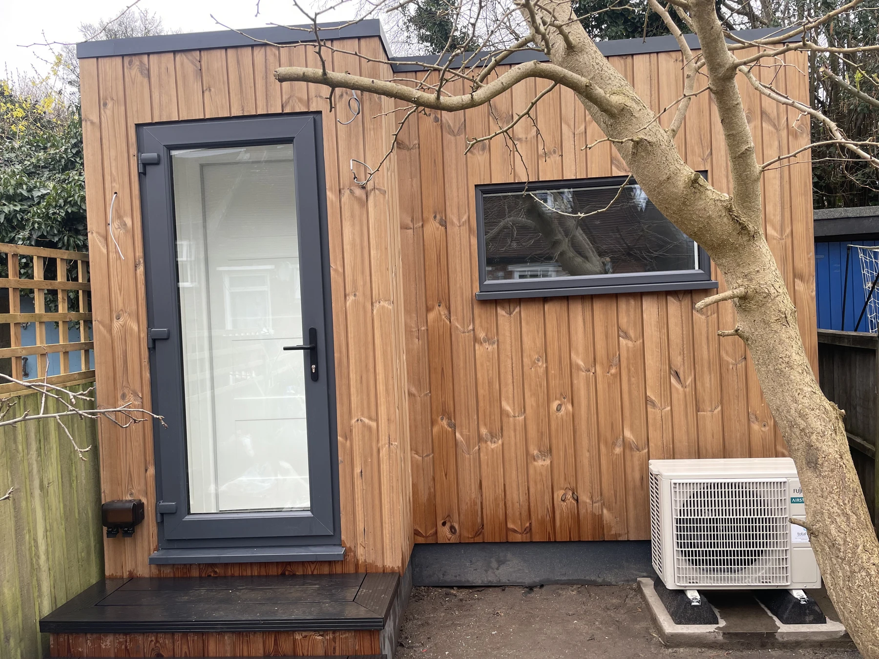 Timber-clad acoustic music studio with glazed entrance in Chesham