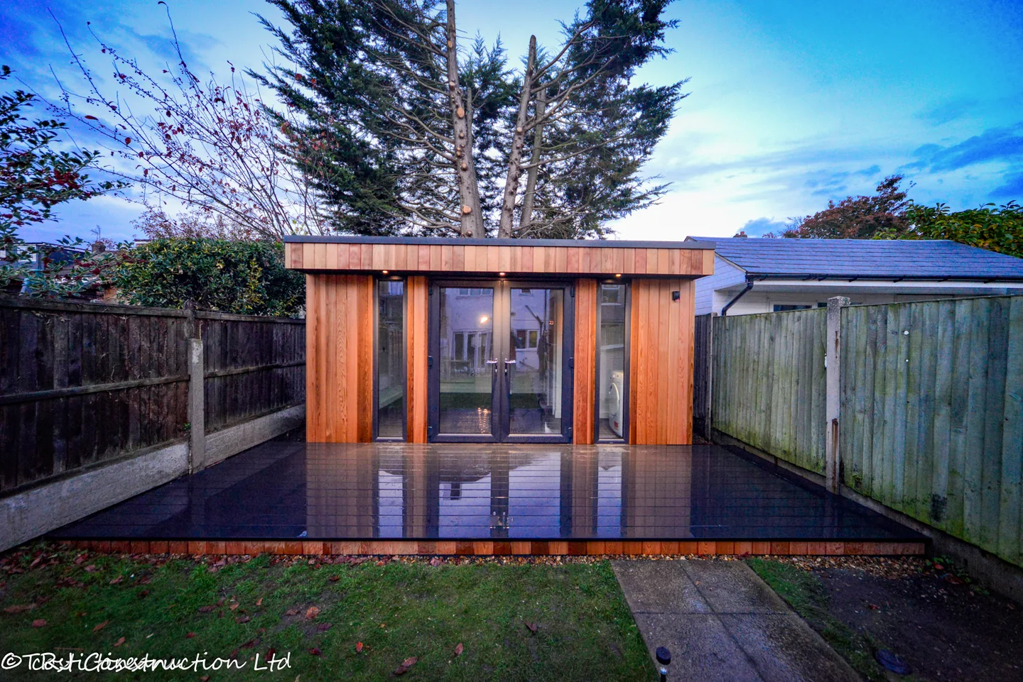Front view of the Havering garden studio with cedar frontage and composite deck