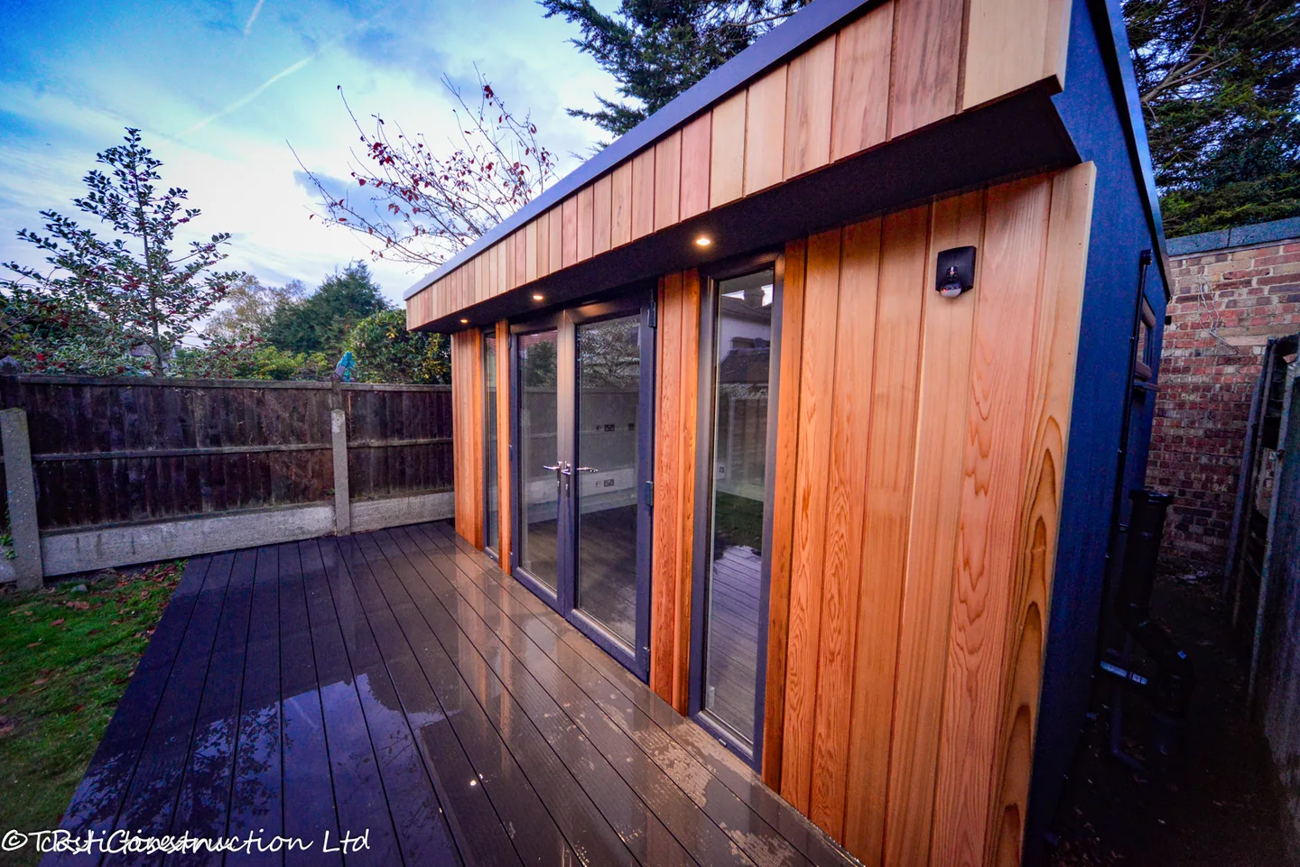 Cedar cladding and exterior downlights beside the Havering studio deck