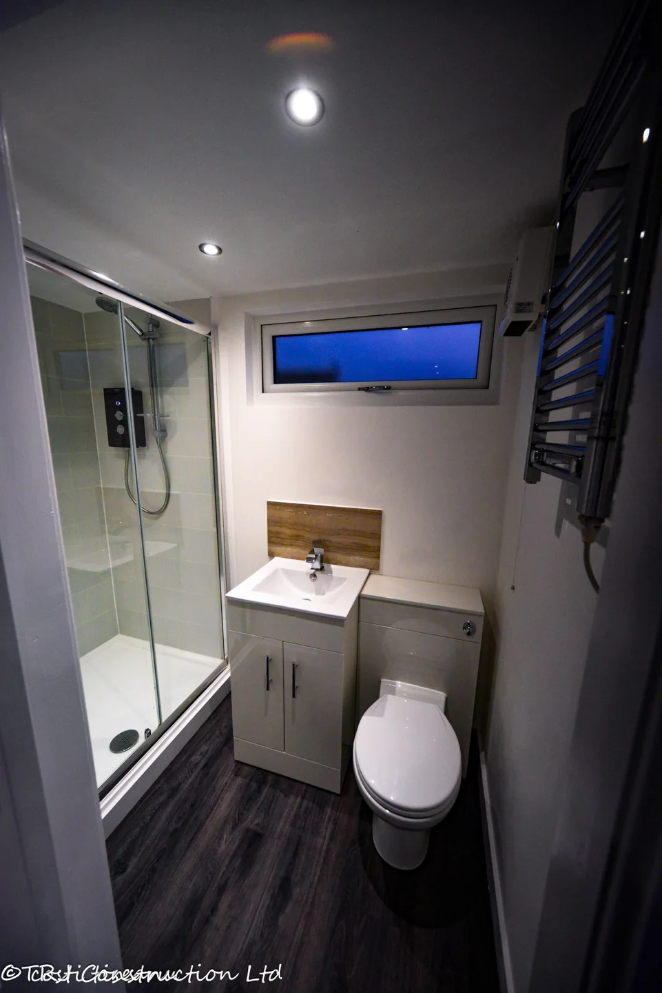 Ensuite shower room with vanity basin, toilet and frosted window