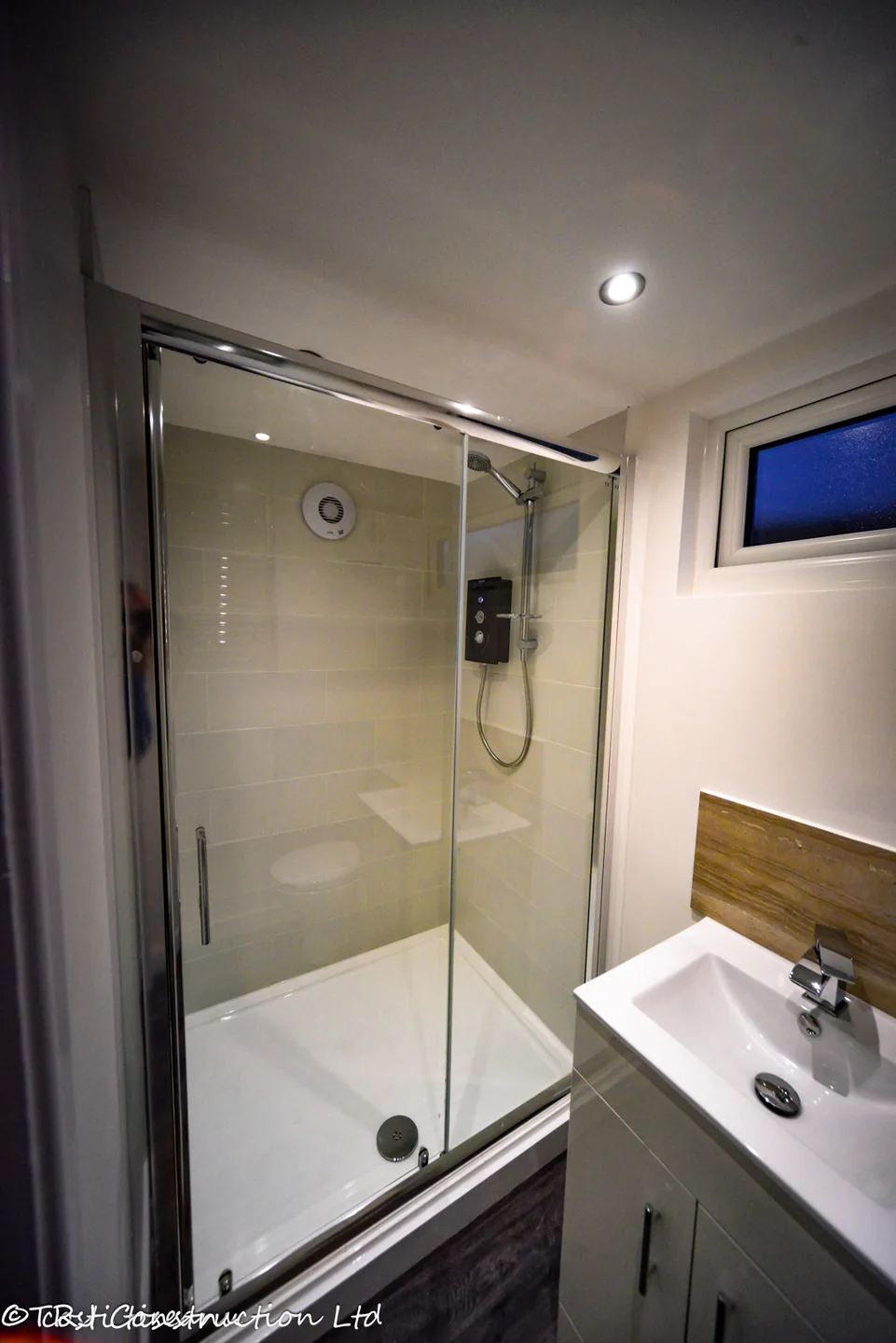 Glazed shower enclosure and vanity basin in the Havering garden room