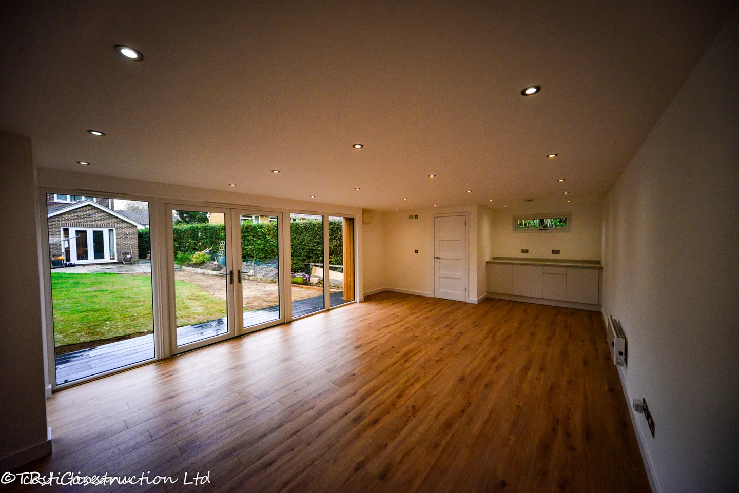 Finished studio interior with broad glazing and fitted cabinets