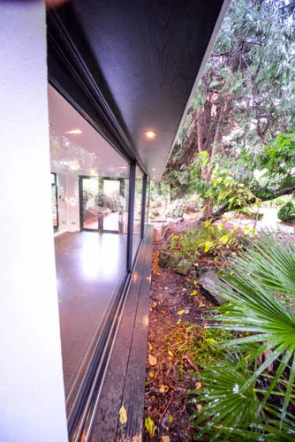 Covered glazed frontage and planting beside the deck