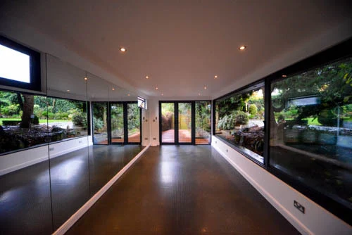 Long mirrored wall and views through the glazed corner