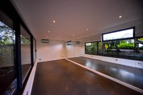 Rubber gym floor, ceiling lights and high-level windows