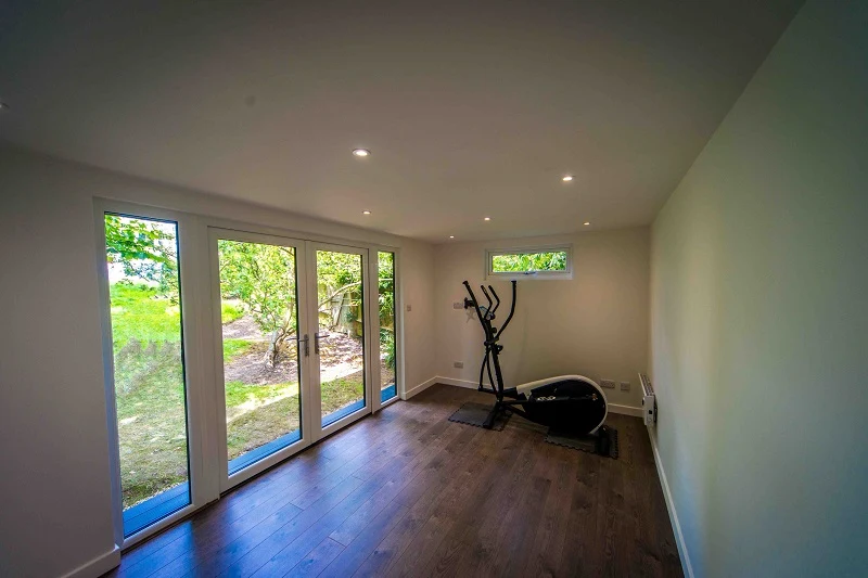The Highgate gym interior with exercise equipment and garden-facing glazing