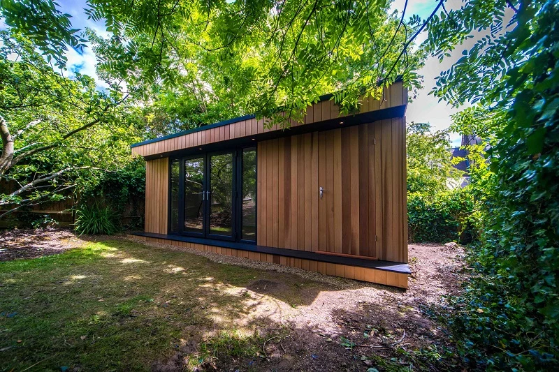 Garden gym with hidden storage beneath the trees in Highgate, London