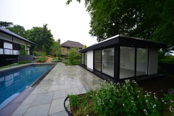 Rendered garden gym and office beside the swimming pool in Sevenoaks