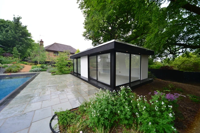 Corner glazing and paved poolside approach to the Sevenoaks studio