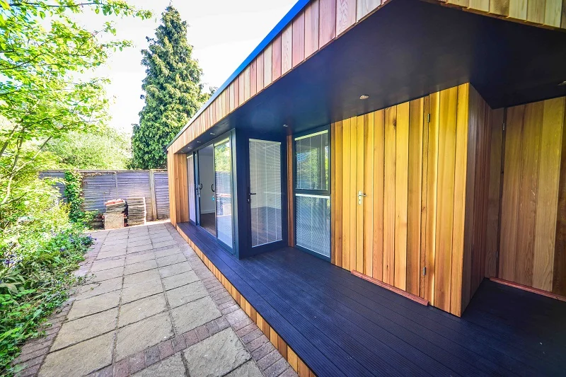 Cedar-clad storage doors and covered threshold