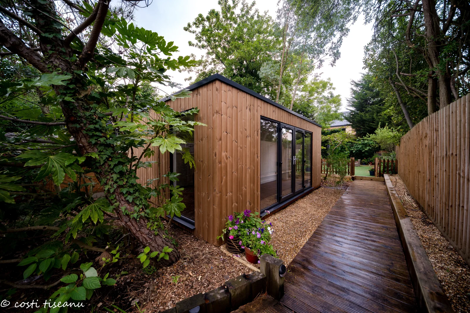 Essex garden office with storage beside the timber garden walkway