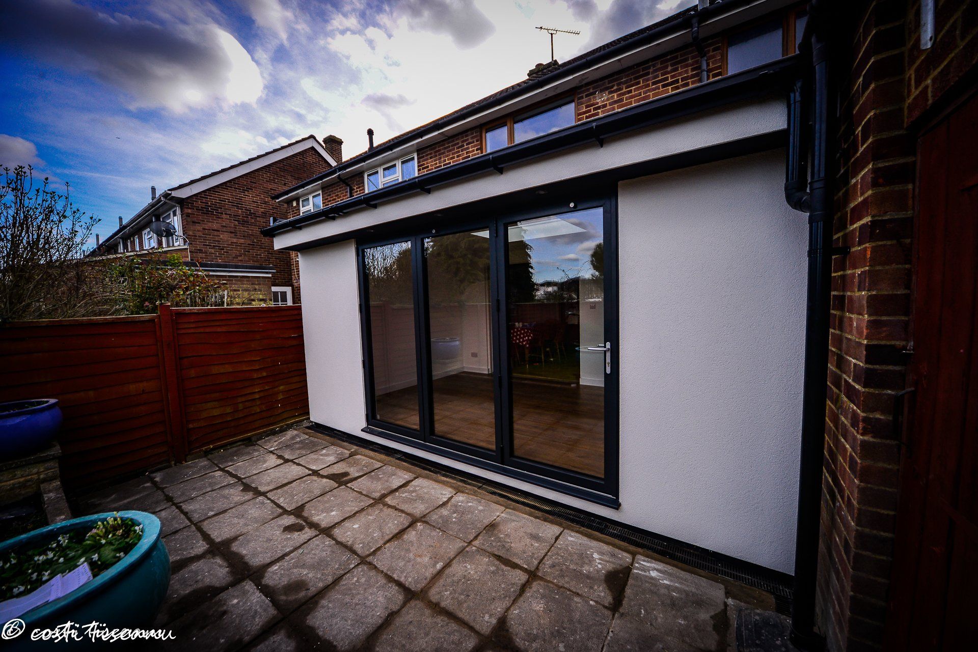 Rendered rear extension with dark-framed garden doors