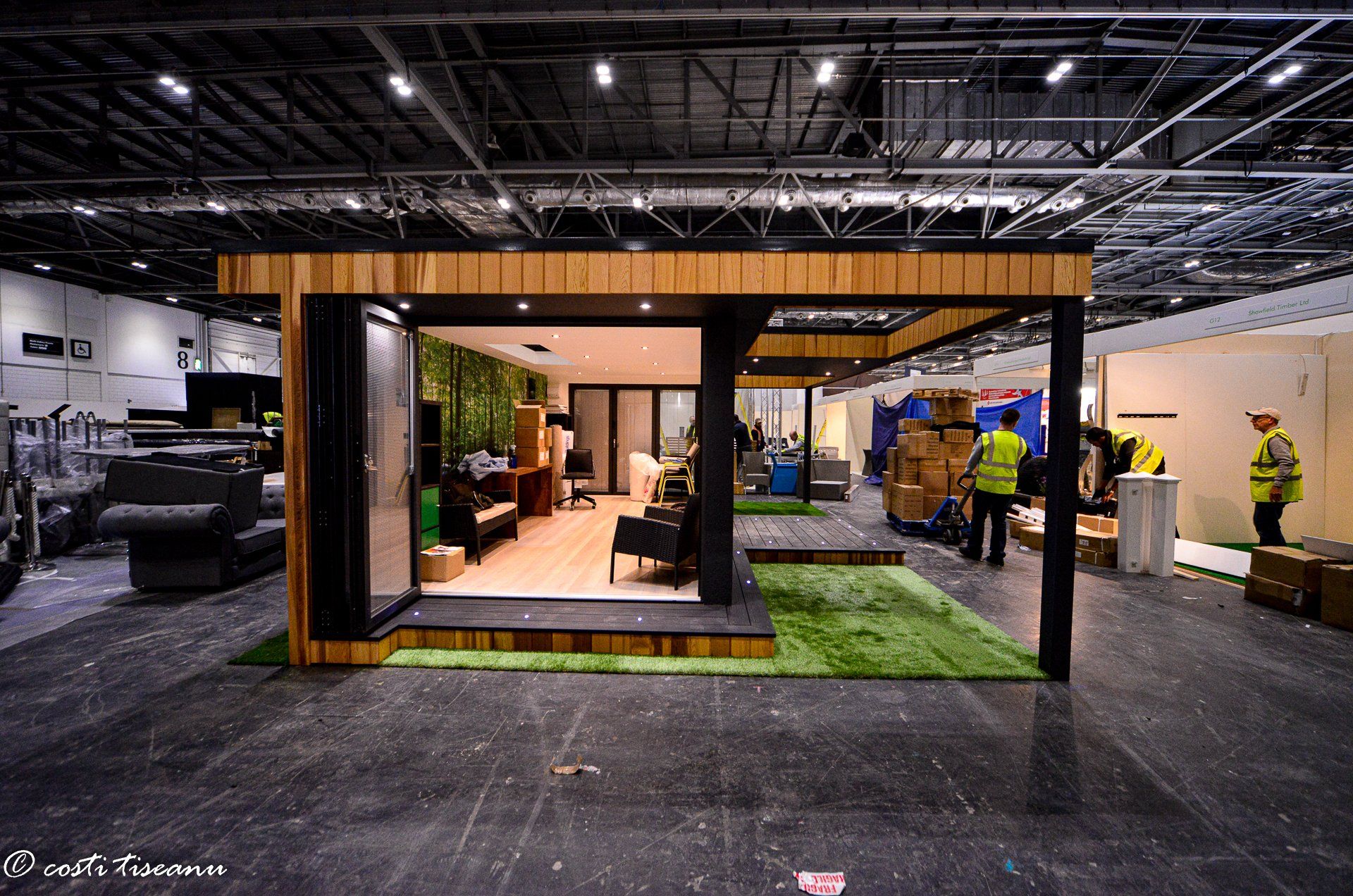 Garden room exhibition stand with glazed frontage and timber canopy