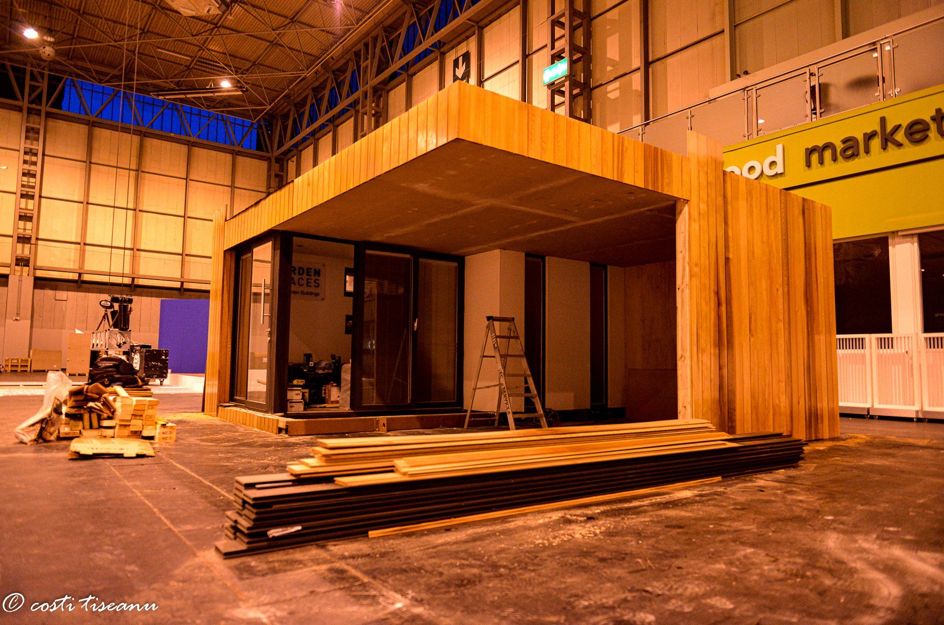 Garden building displayed beneath exhibition-hall lighting