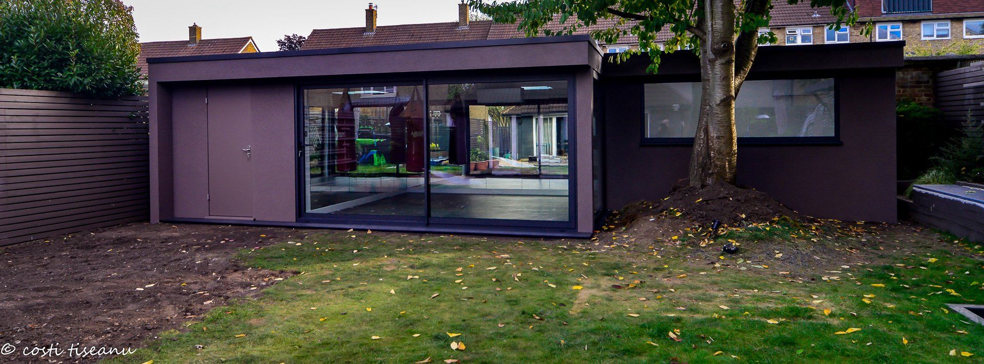 Garden gym exterior with dark frames and glazed doors