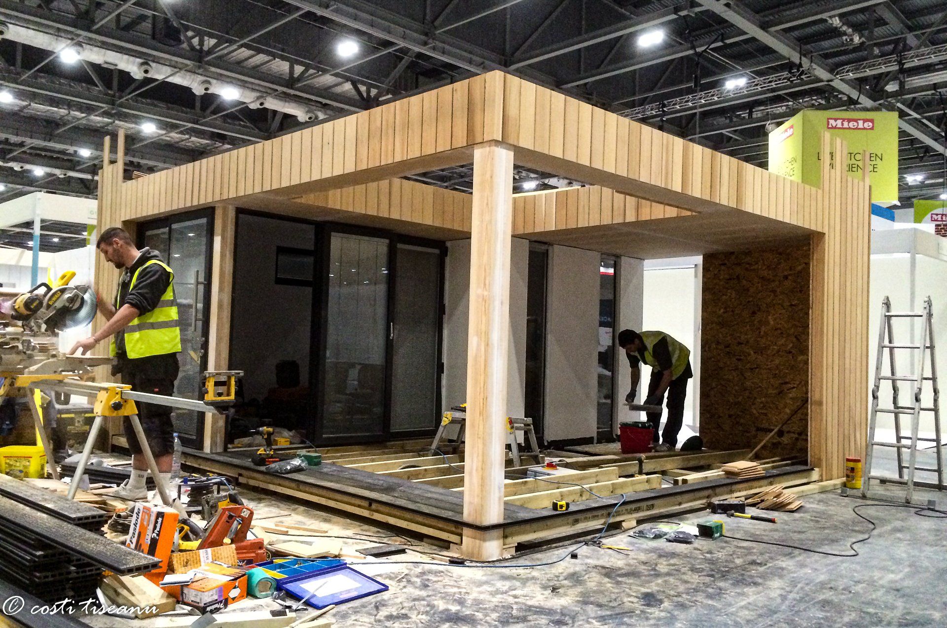 Garden-room shell and materials during exhibition setup