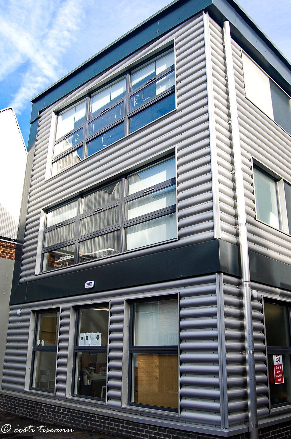 Corner view of the metal-clad commercial annexe
