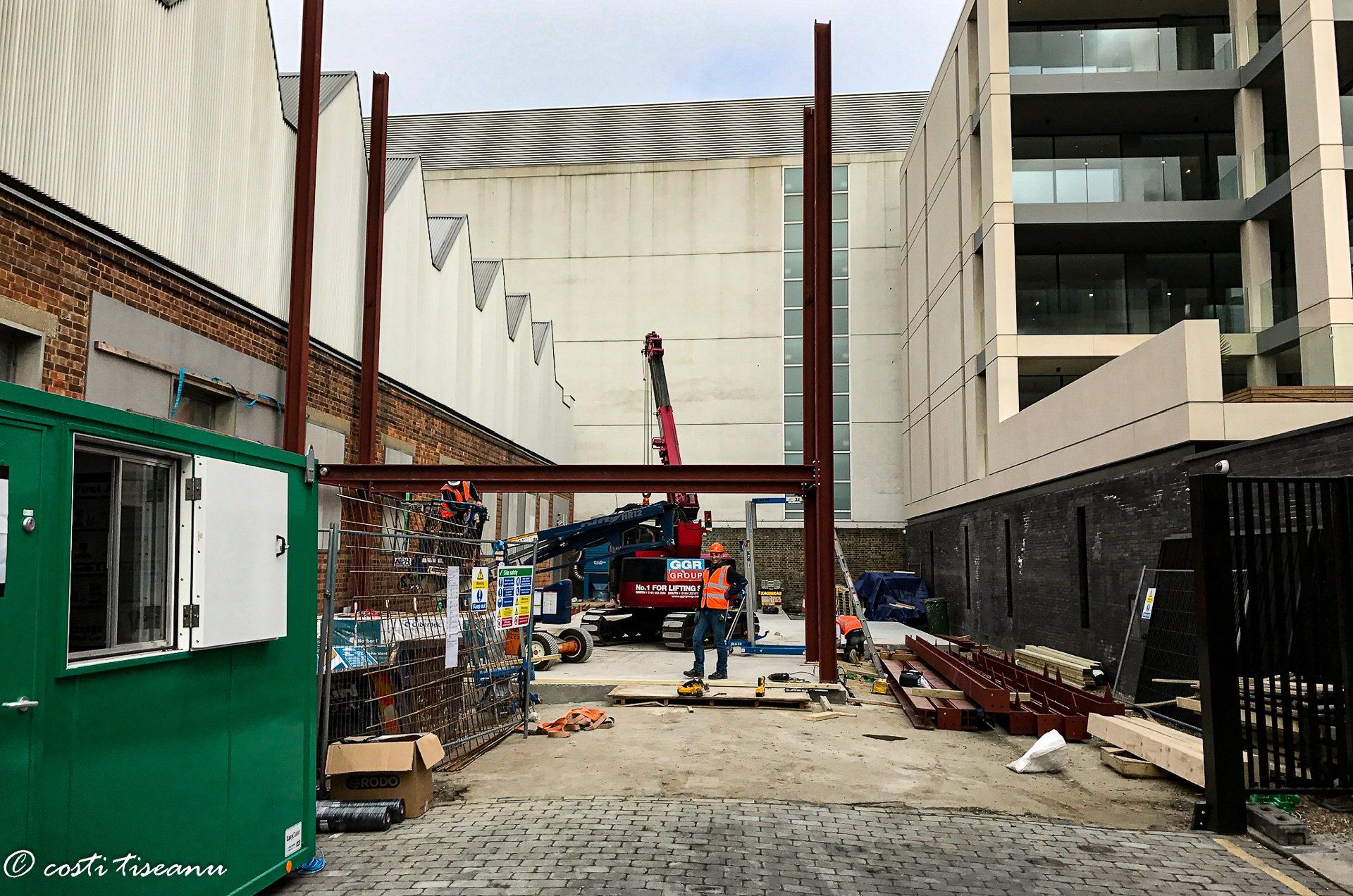Commercial building site with structural steelwork and lifting equipment