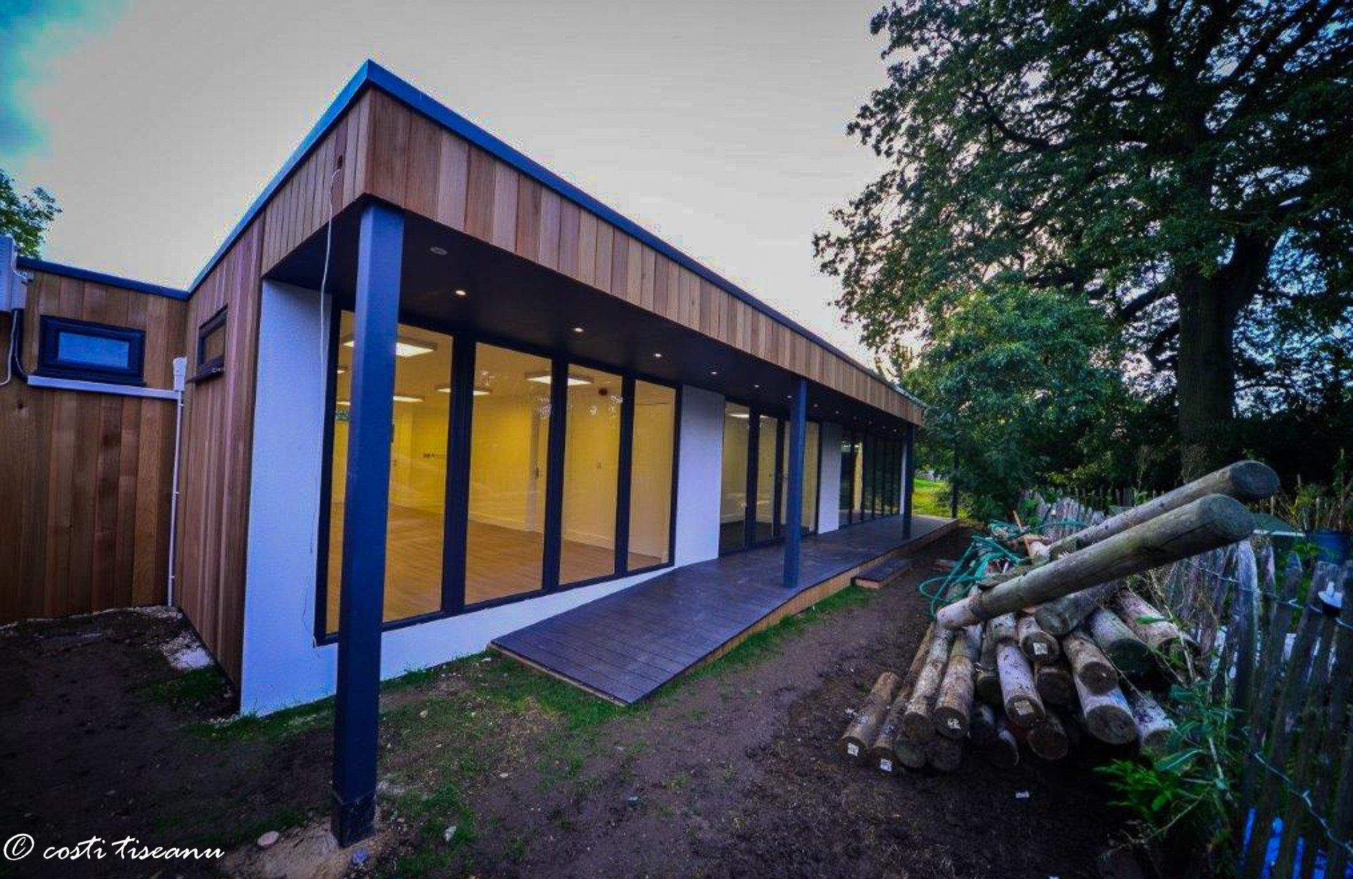School classroom with timber cladding beside mature trees