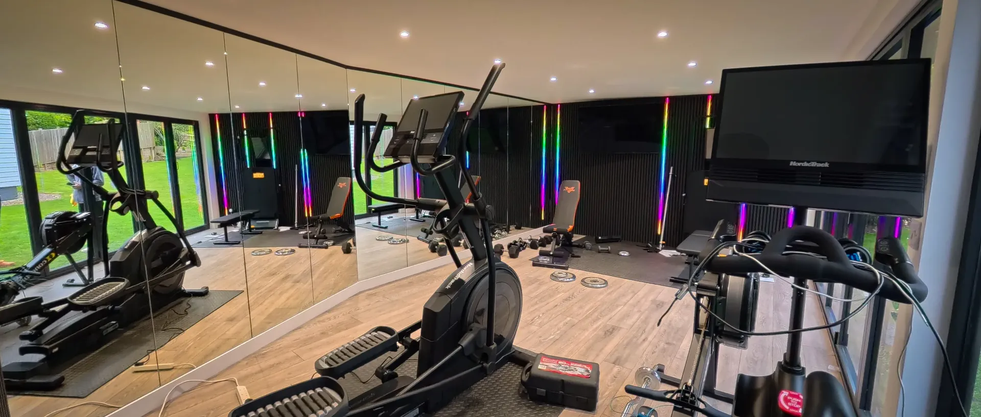 Fitness equipment beside full-height garden windows