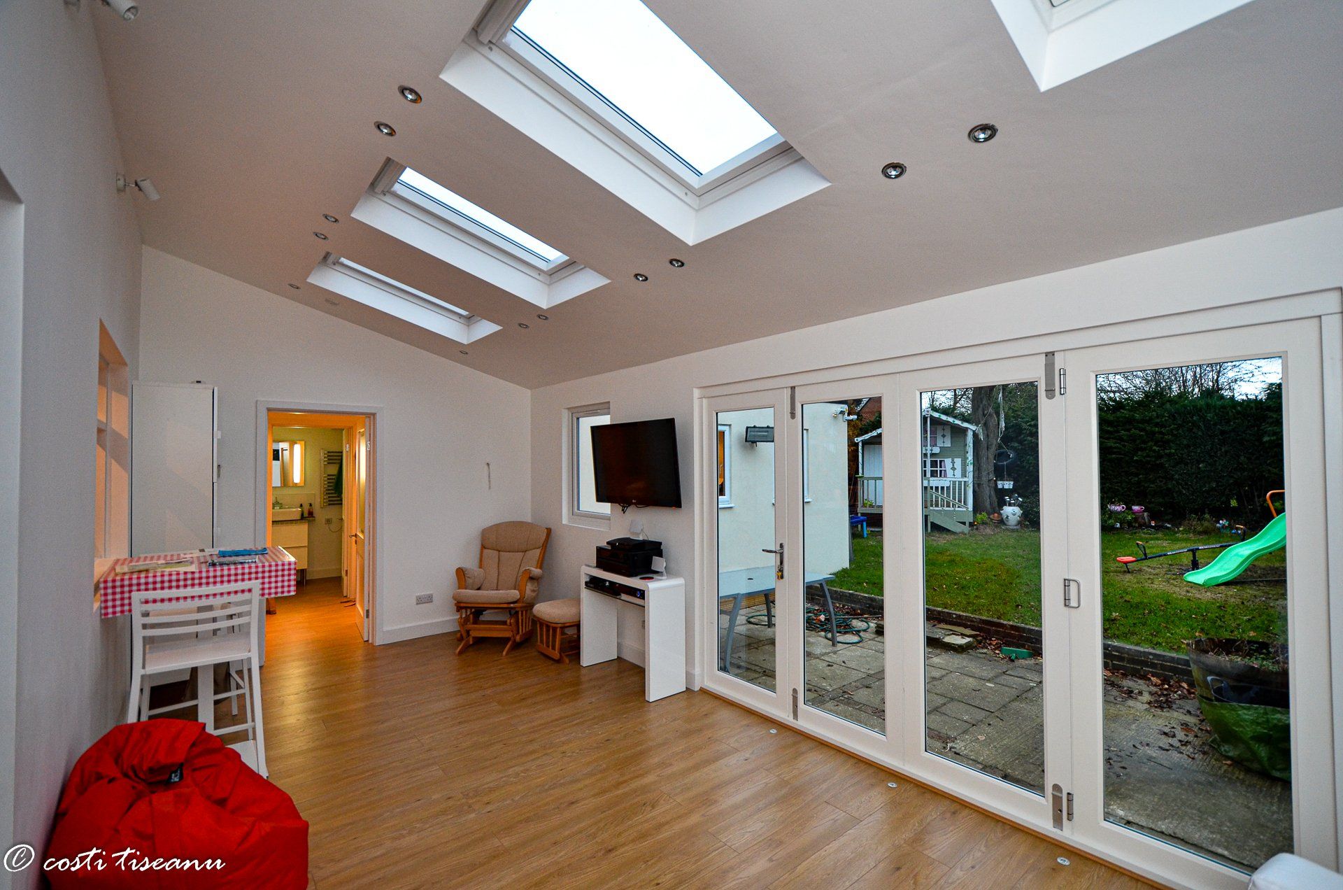 Bright extension interior with rooflights and glazed doors