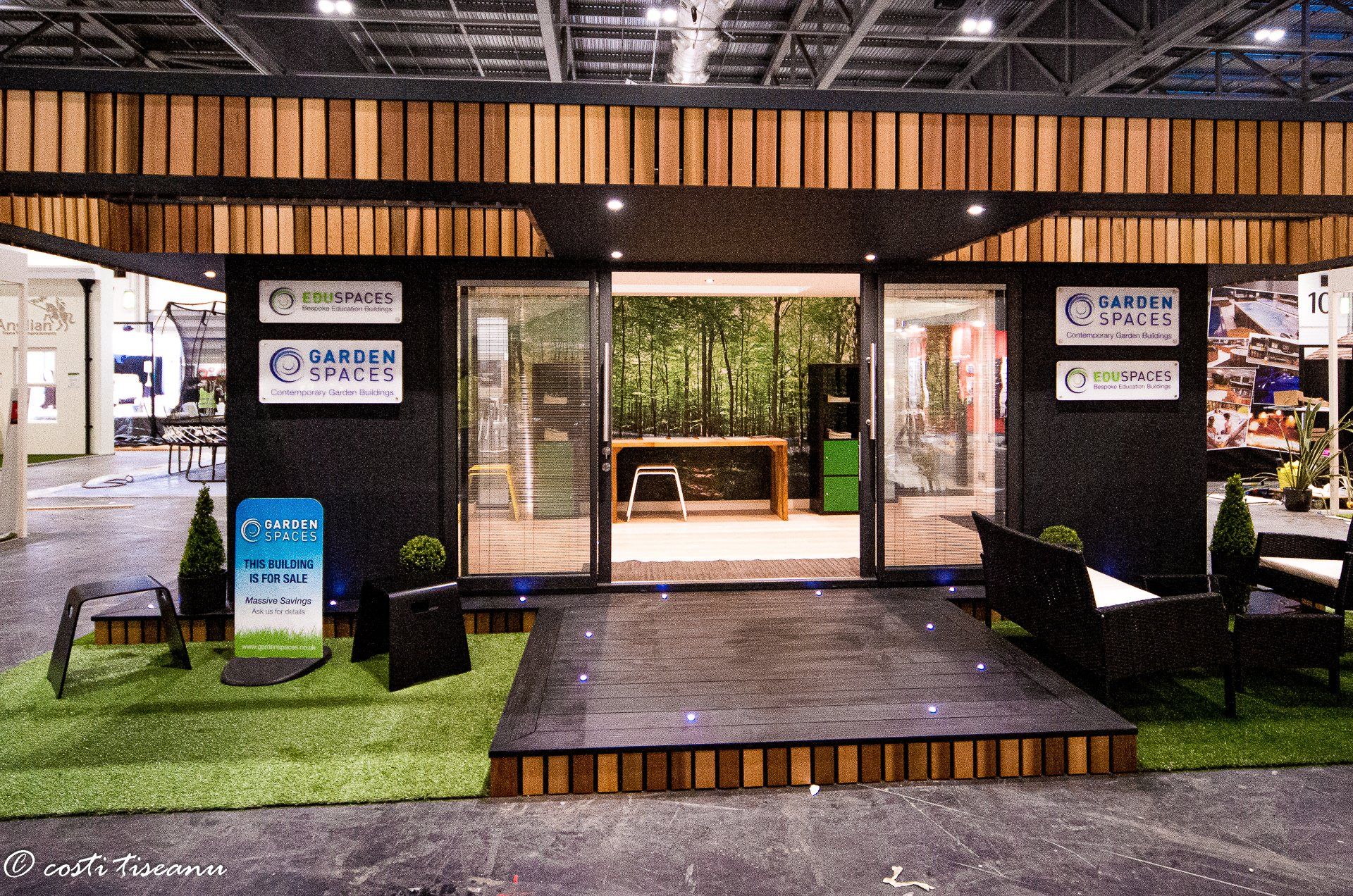 Garden room display with a timber deck and landscaped stand