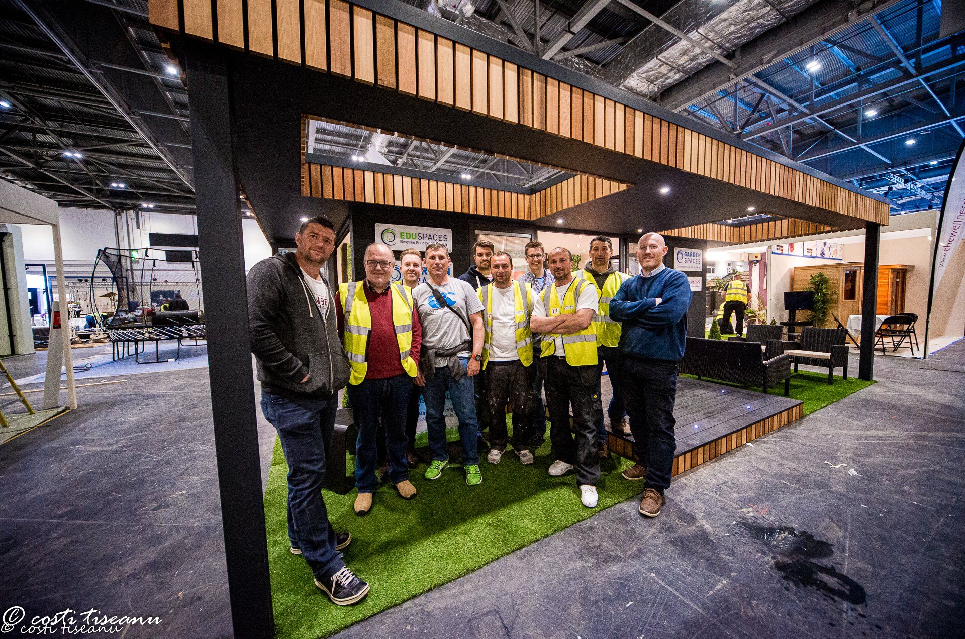 Exhibition installation team beside the garden-room stand