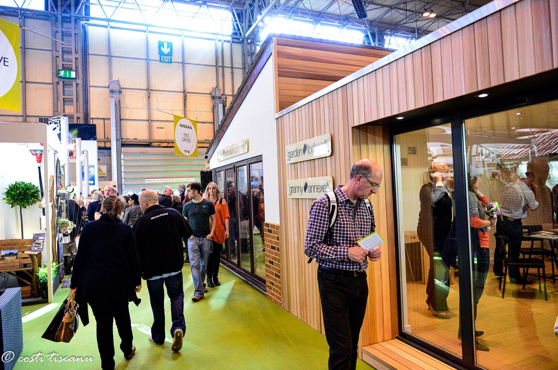 Visitors beside the garden-room exhibition display