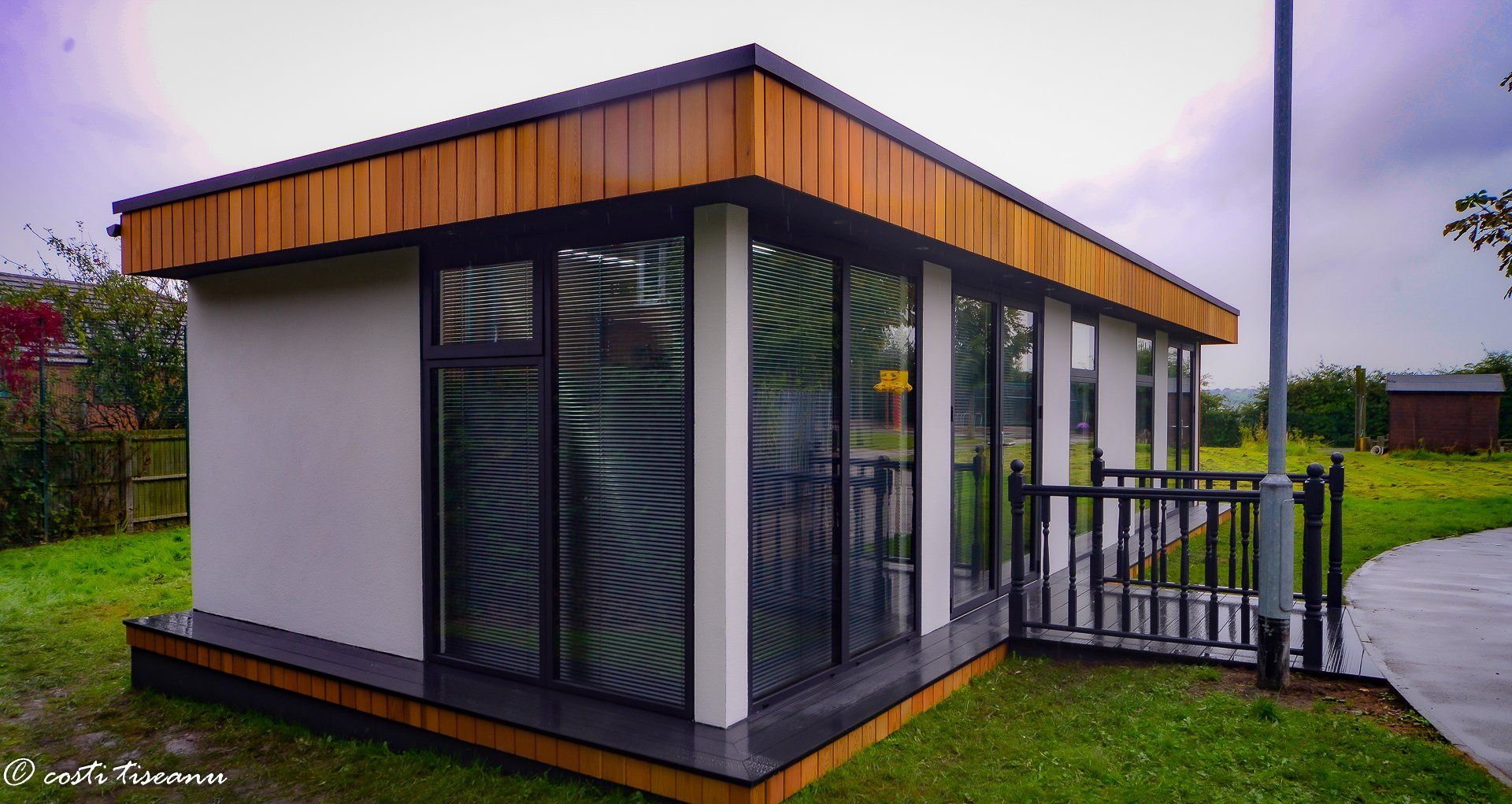 School building with glazed frontage and a timber roof edge
