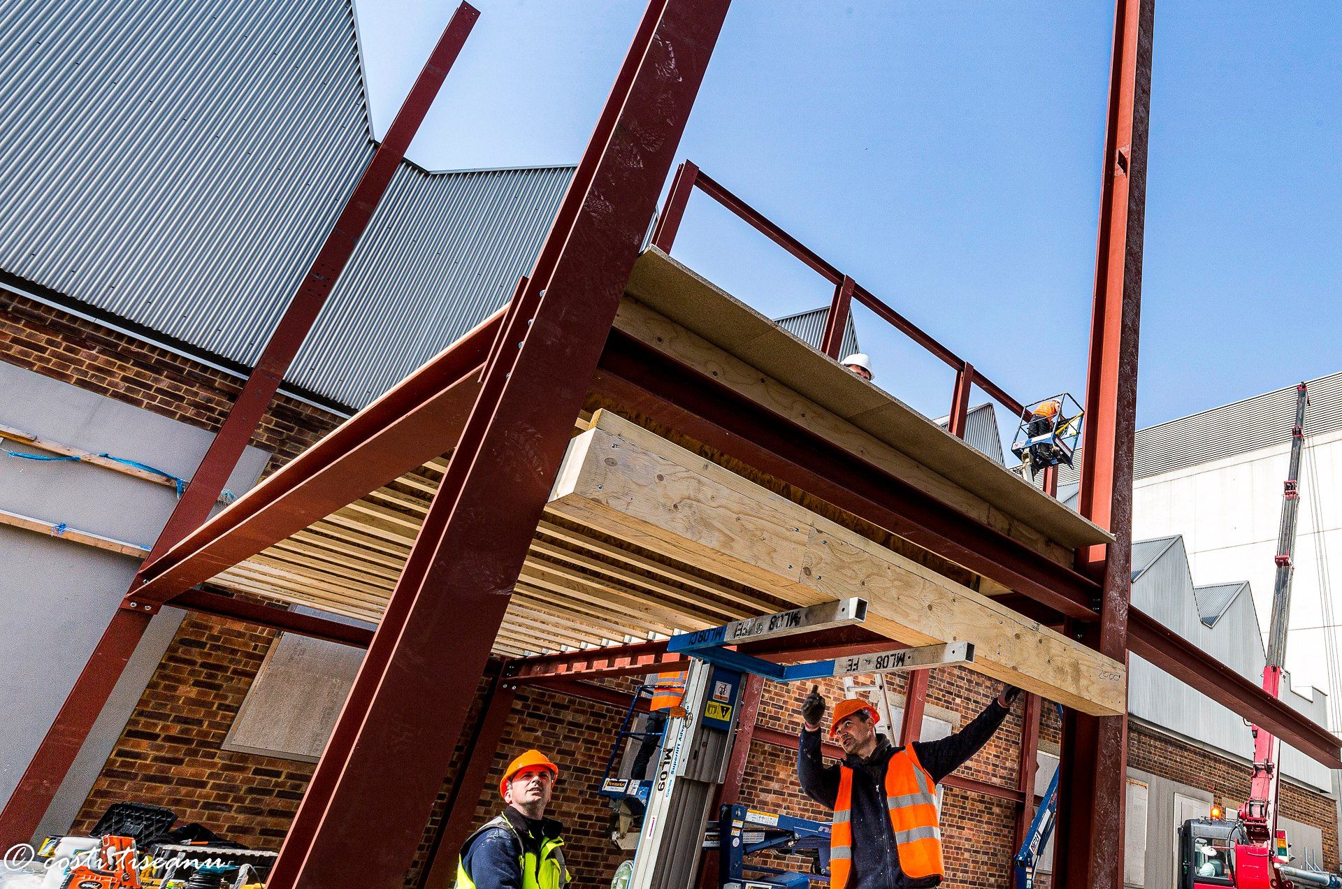 Installation team beneath the steel frame and floor structure