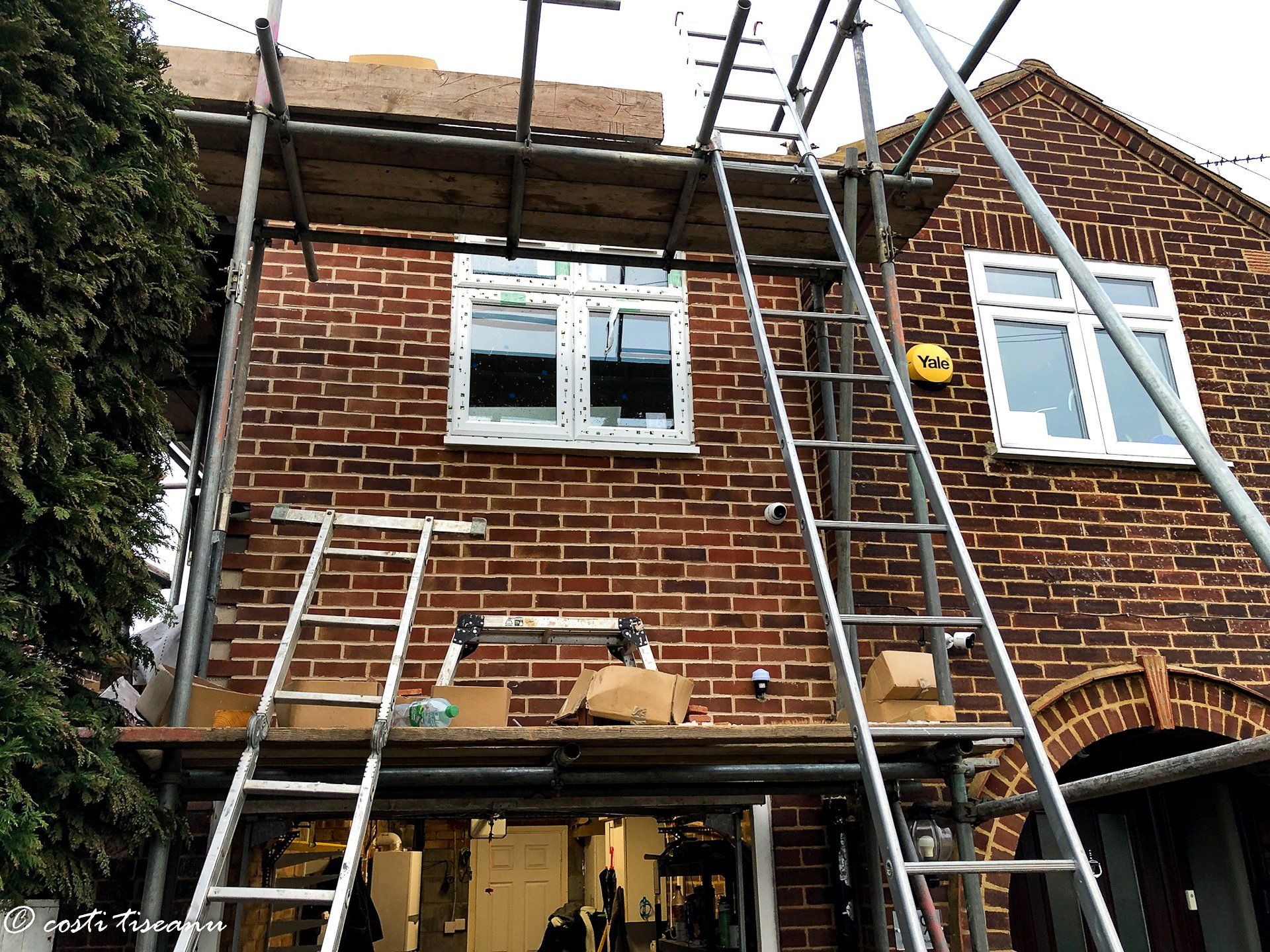 Scaffold and access equipment beside the existing house