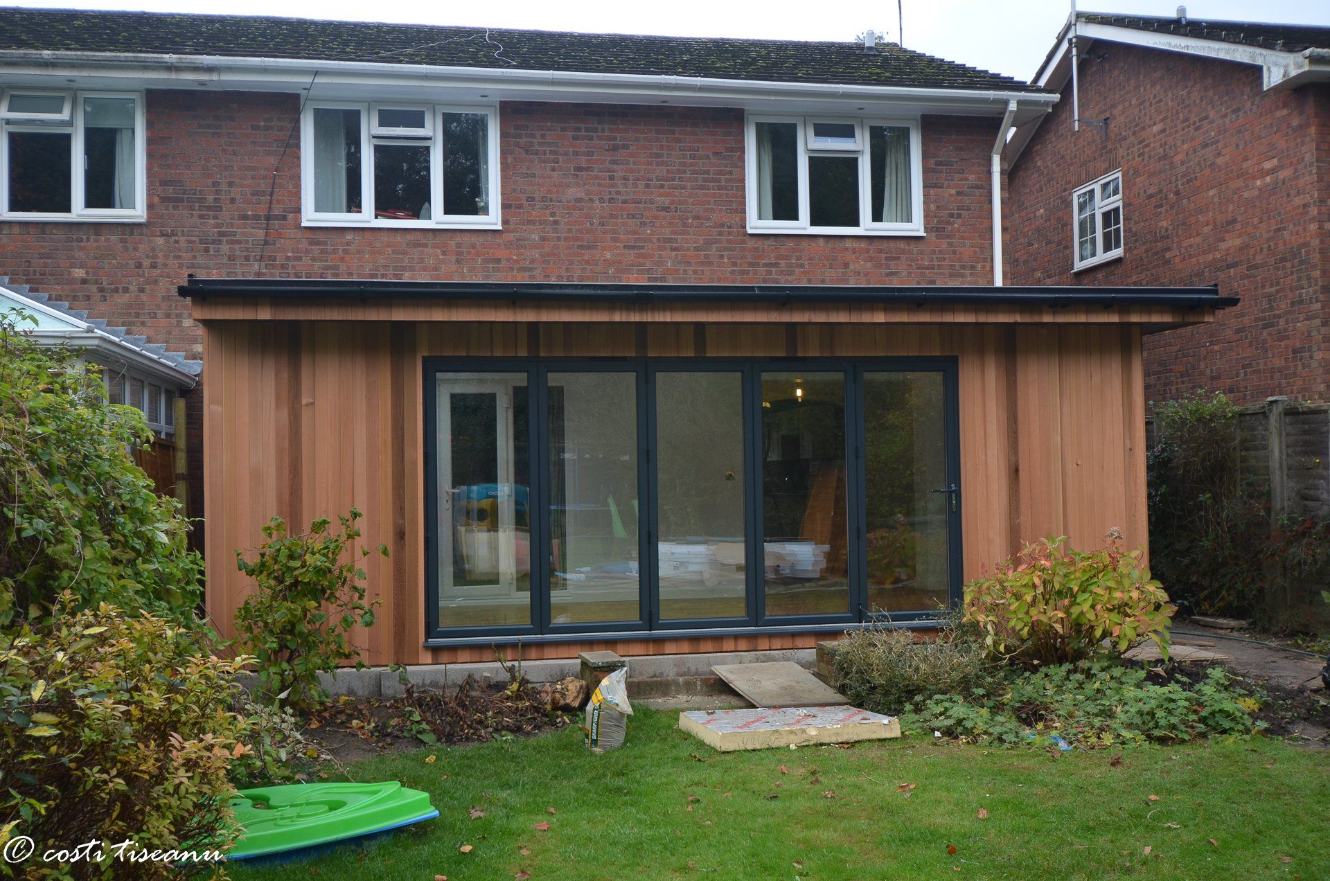 Timber-clad extension with full-height garden-facing glazing
