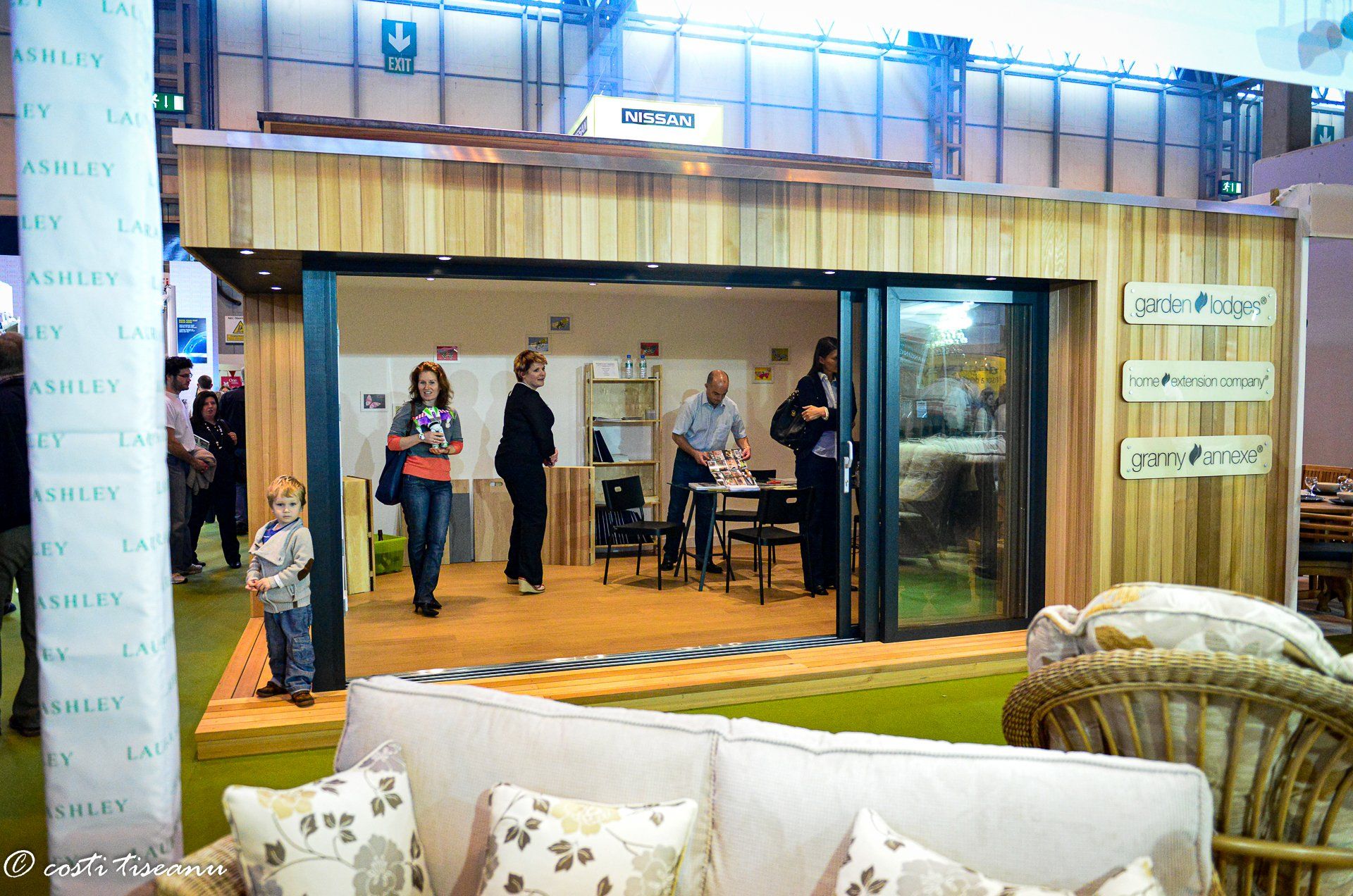 Visitors viewing a finished garden-room stand