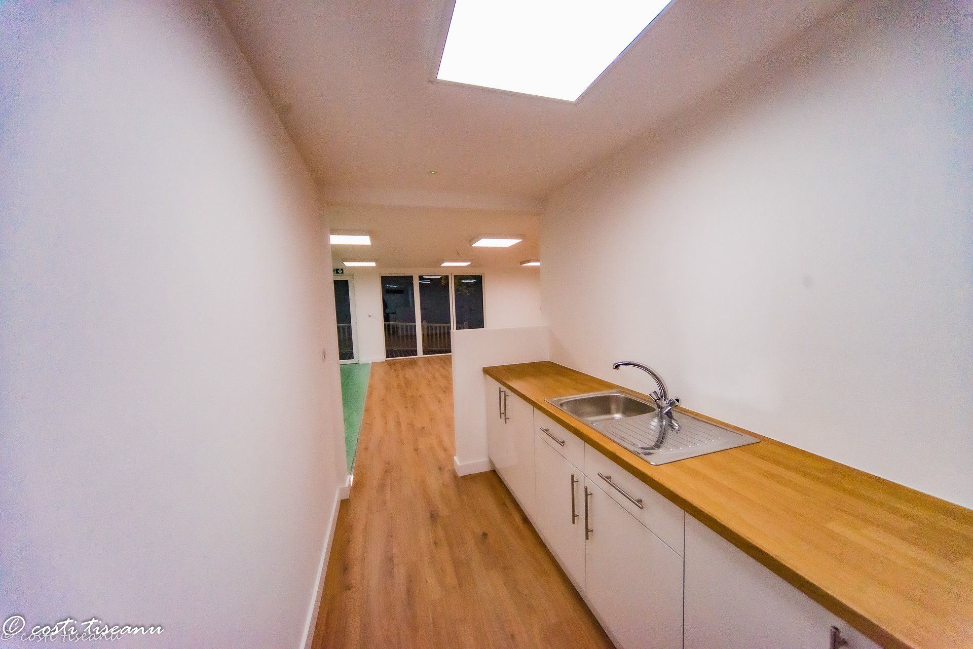 School-building kitchenette beneath a rooflight