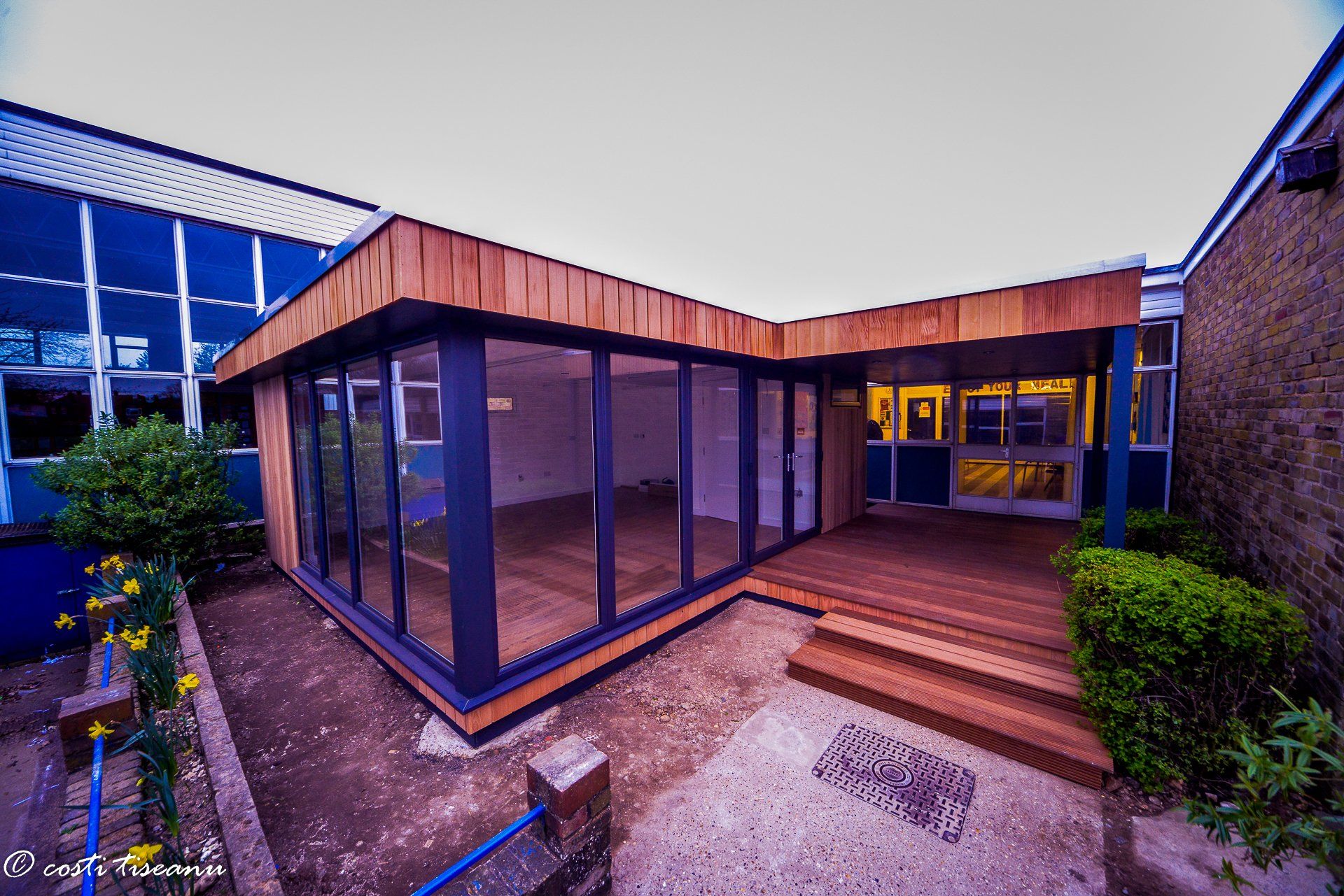 Timber-clad classroom beside the existing school block