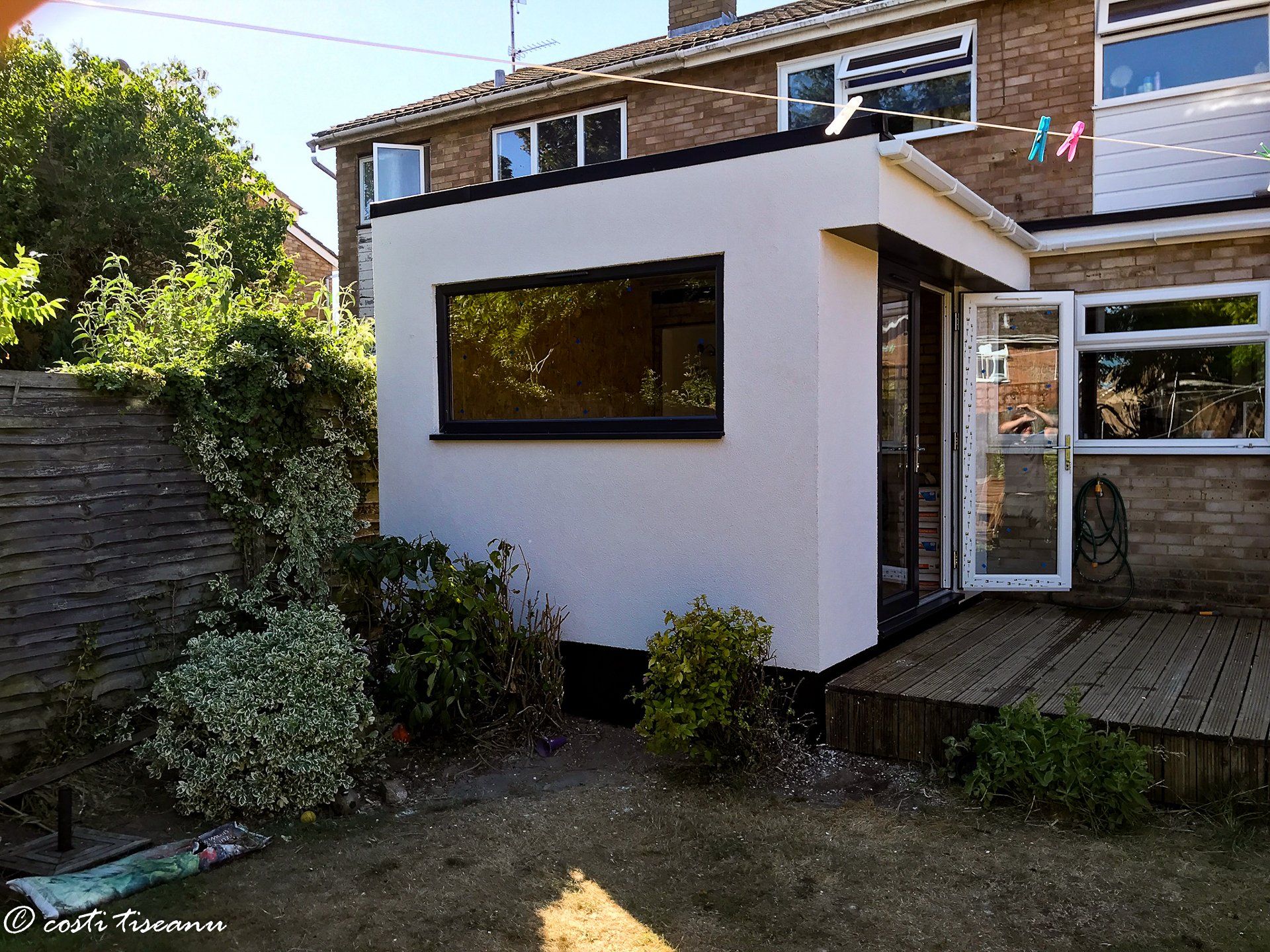 Rendered rear extension with a large garden-facing window