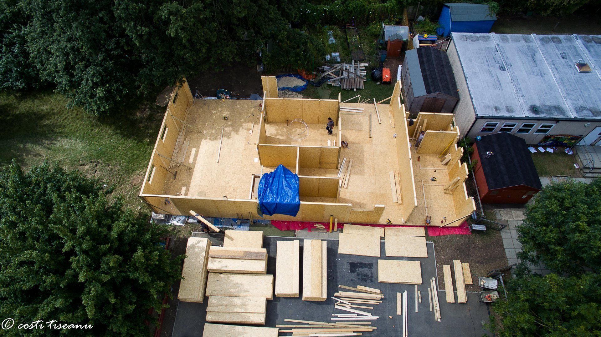 School building under construction with wall panels and interior framing