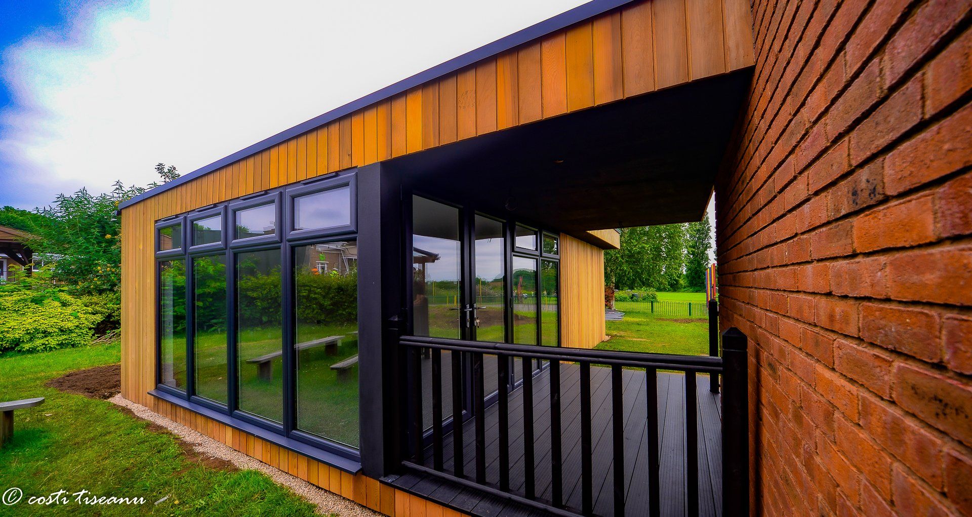 Timber-clad classroom frontage beside the existing building