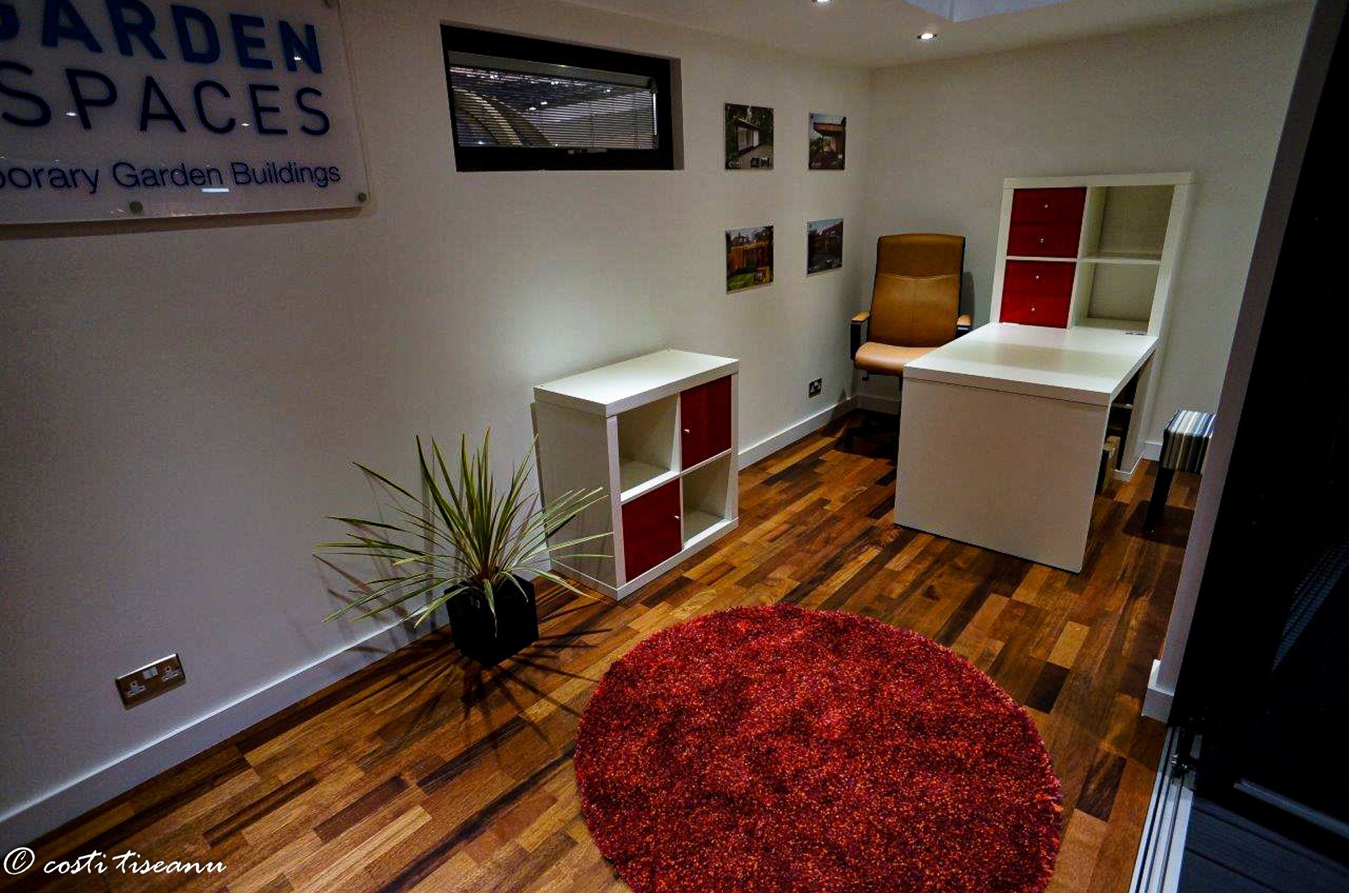 Compact exhibition interior with a chair and storage