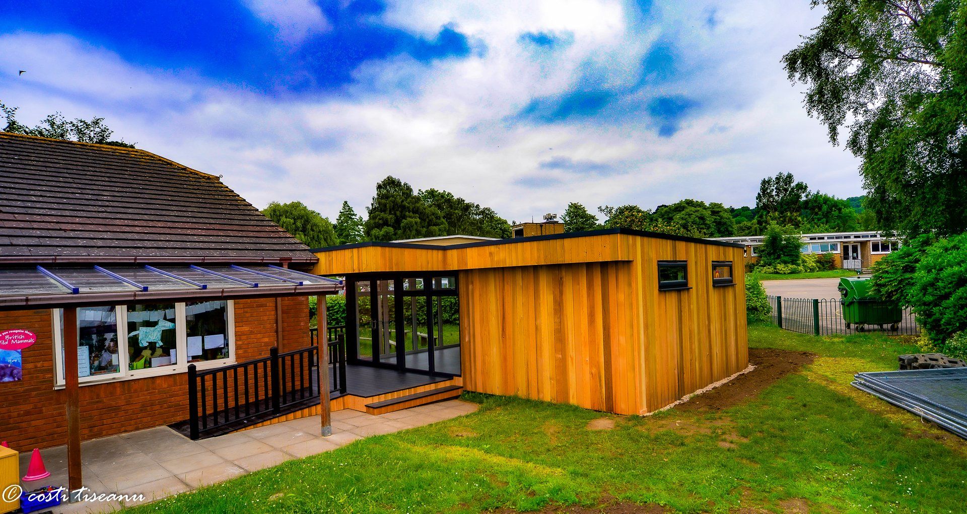 Timber-clad classroom addition beside the existing school