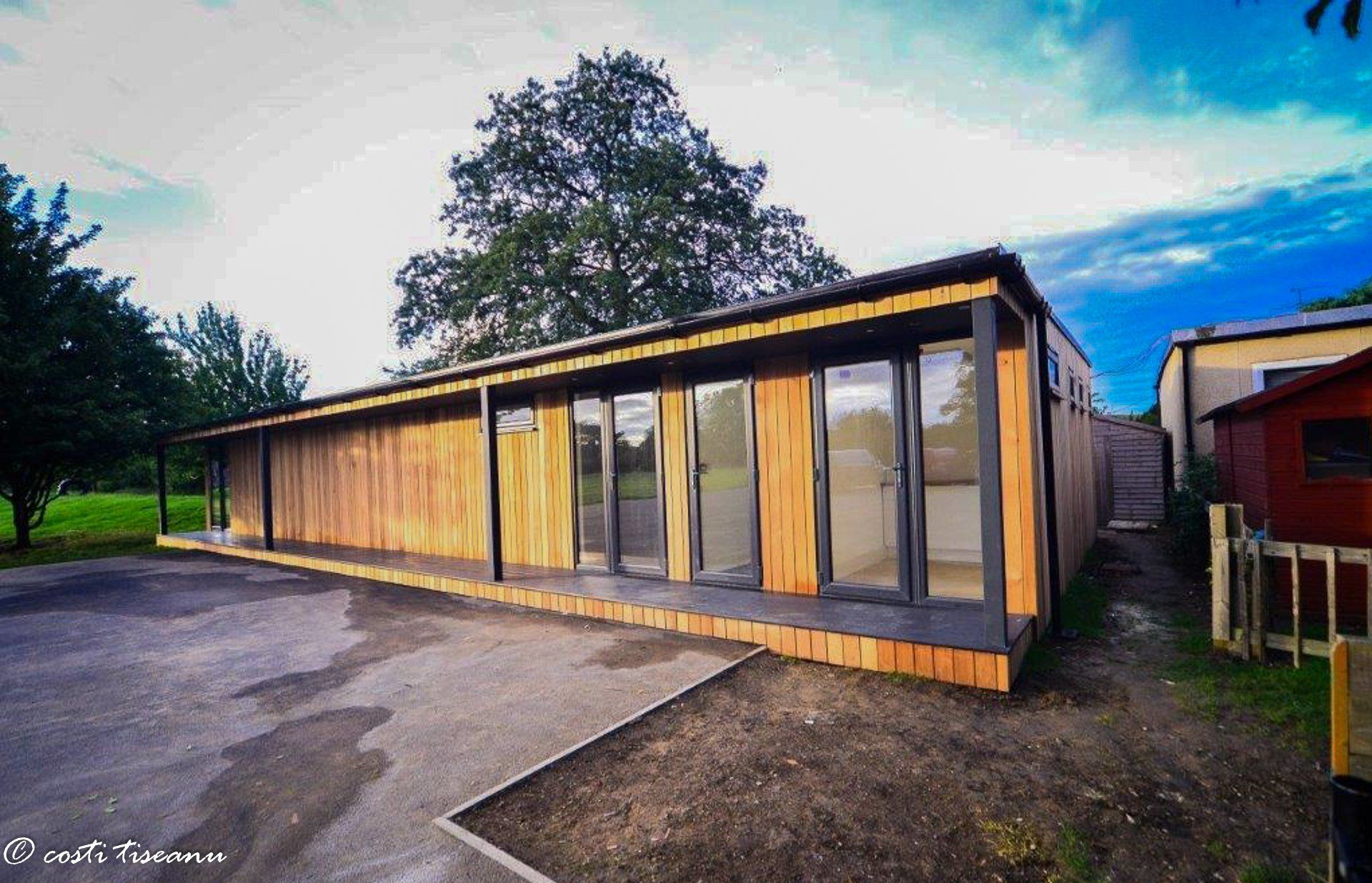 Long glazed school building beside a paved courtyard