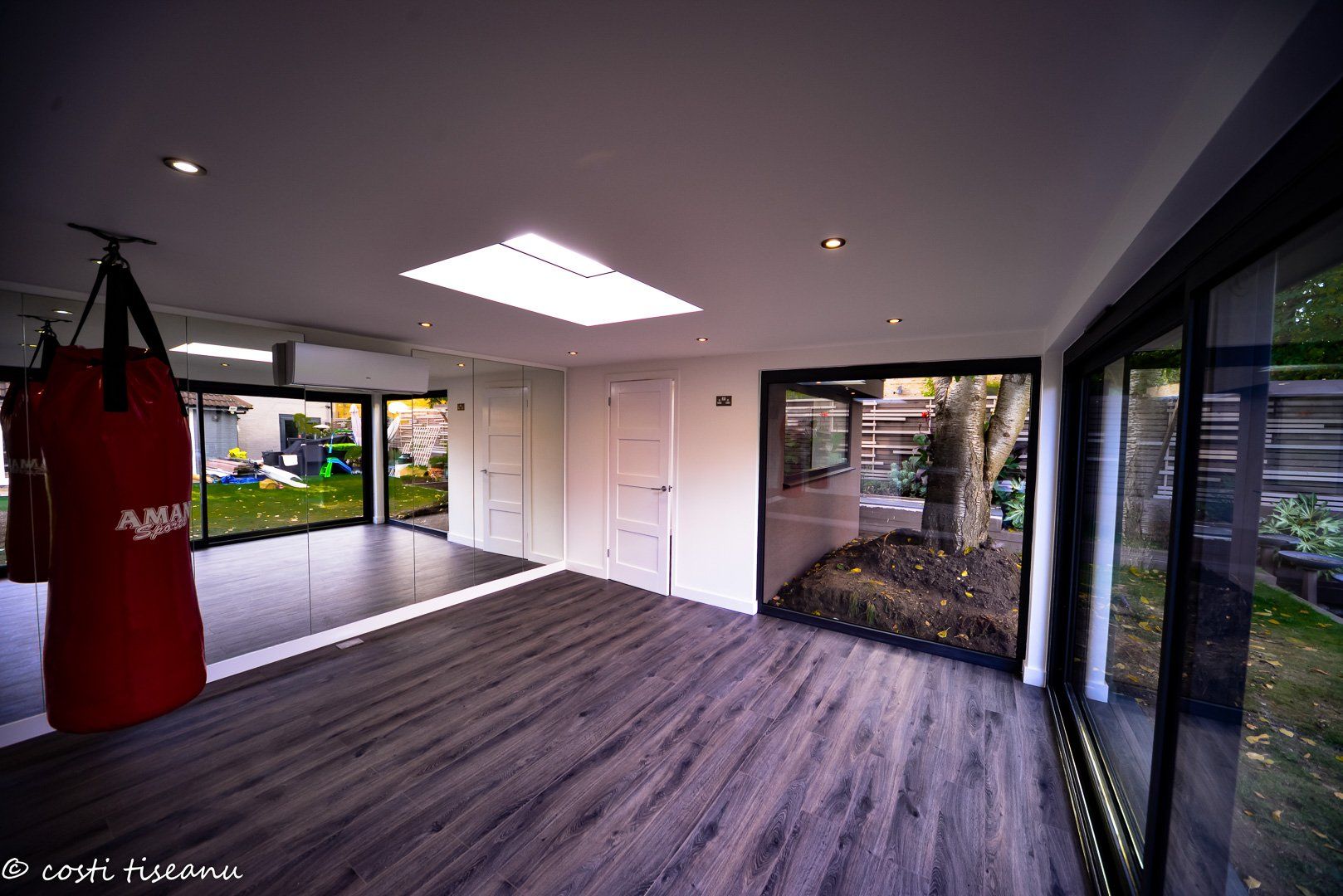 Private boxing studio with a rooflight and punching bag