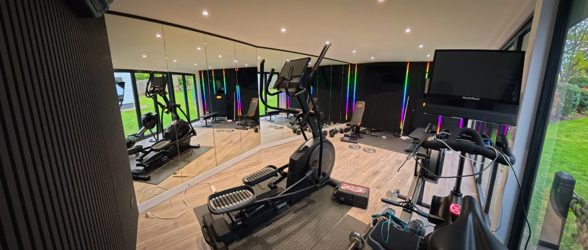 Weights and cardio equipment inside a garden gym