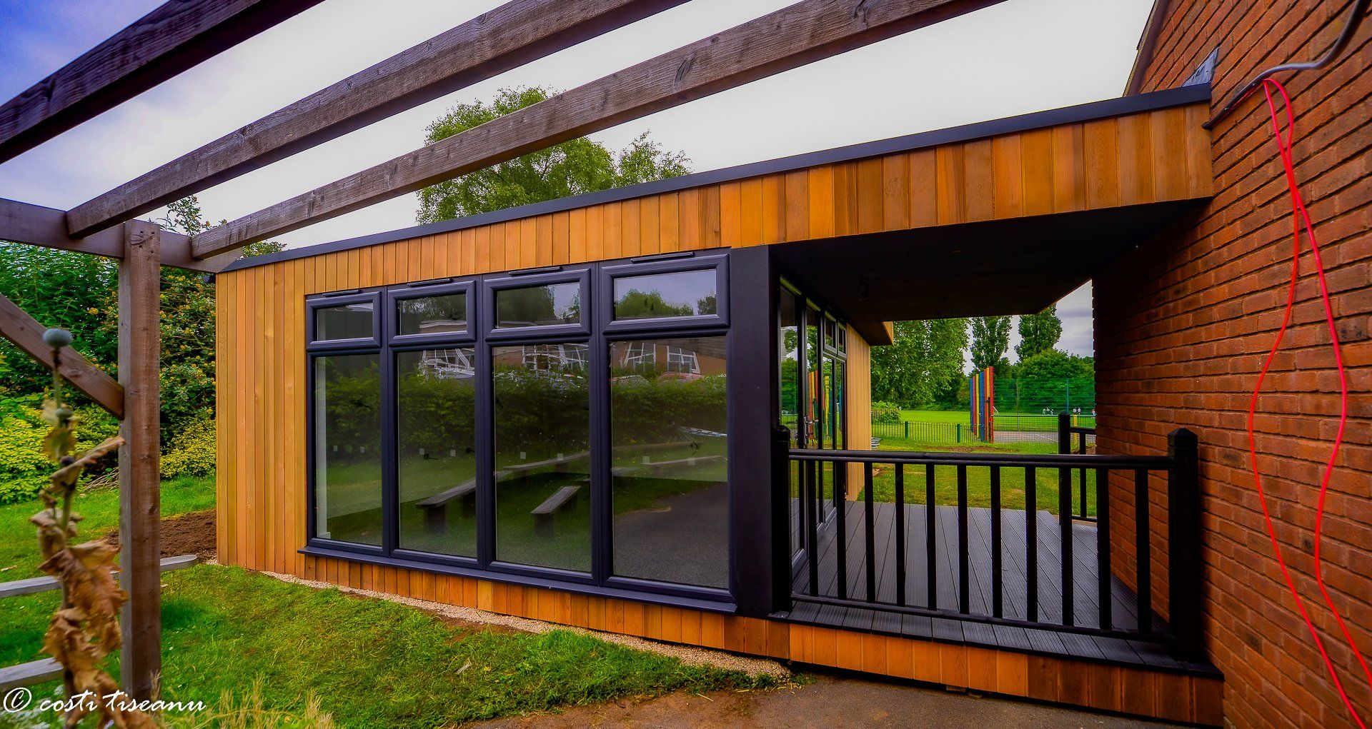 Glazed classroom building with a sheltered entrance