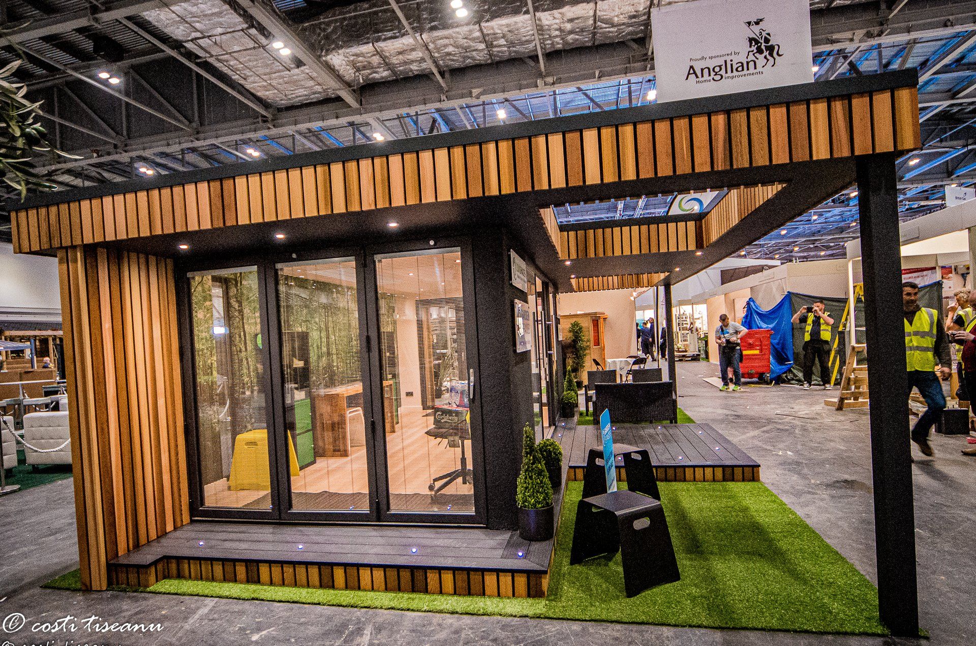 Glazed exhibition-room frontage beneath a slatted canopy