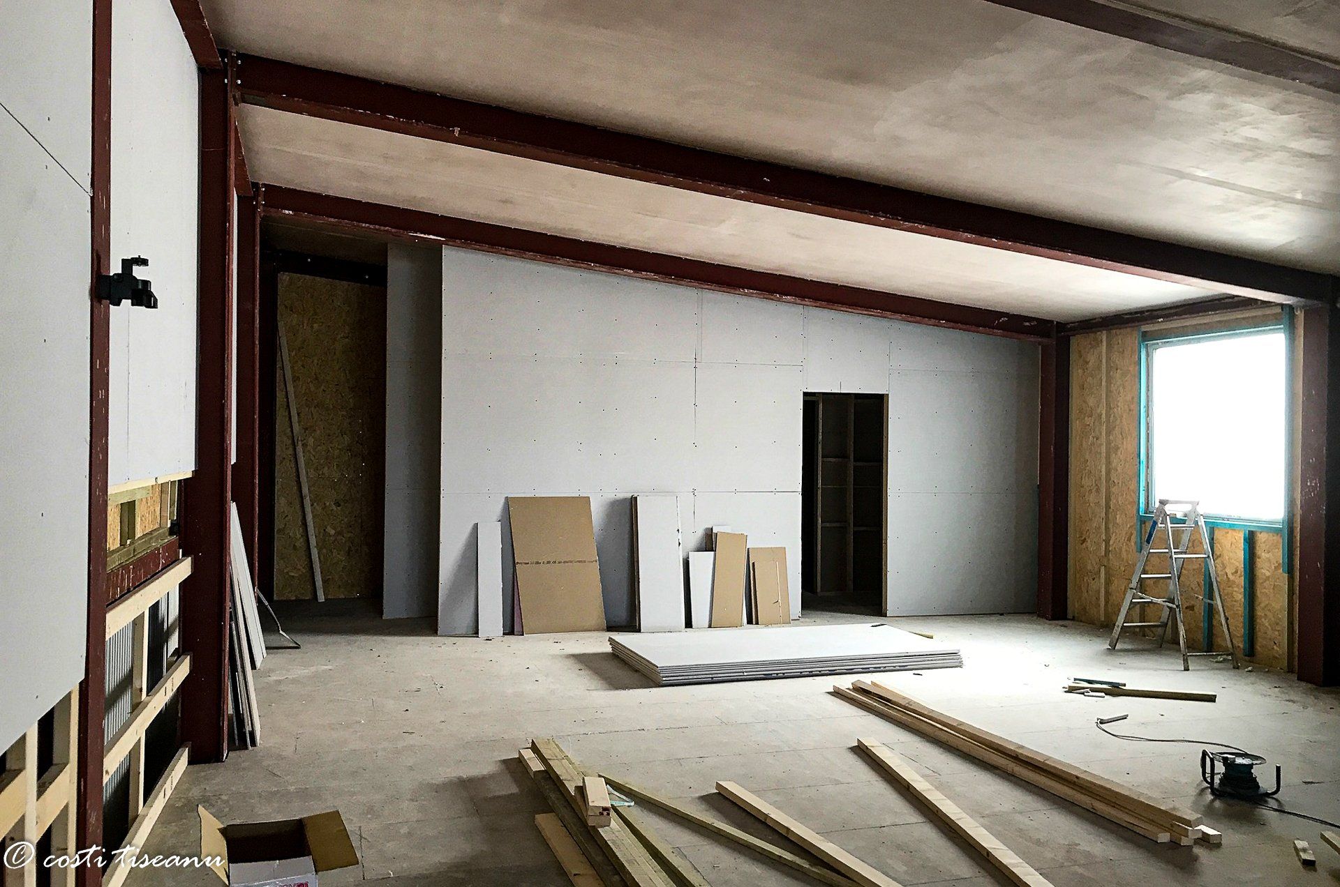 Commercial annexe interior during fit-out with exposed structural beam